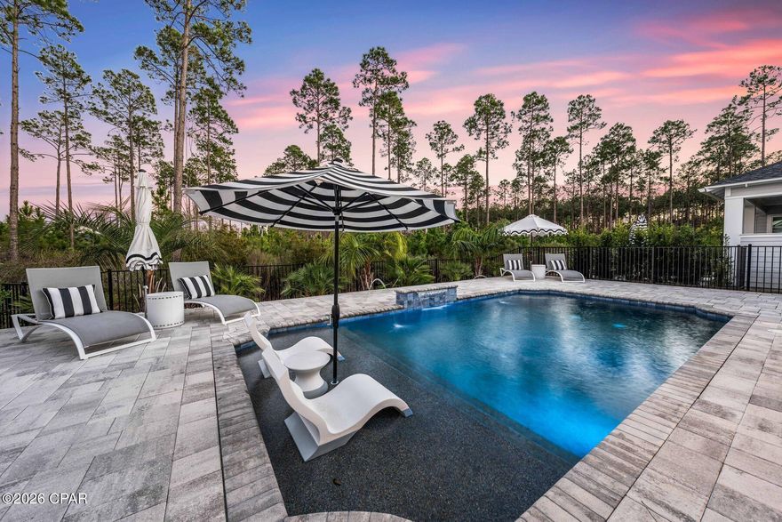 In a community where floor plans are consistent, this NatureWalk at Watersound Origins residence stands out for its level of upgrades and customization rarely seen. Built in 2023, this single-story home offers three bedrooms, two bathrooms, and approximately 1,960 square feet, thoughtfully enhanced well beyond builder-grade standards. From the moment you enter, curated details set the tone, including a Venetian plaster accent wall in the entry and a statement Venetian plaster ceiling in the living room, adding texture and architectural interest. Plantation shutters throughout bring a timeless, cohesive elegance to every space.

The kitchen is elevated with ceiling-height cabinetry, custom upgraded by Shoreline Cabinets to include enhanced storage features such as integrated drawers and a built-in spice rack, complemented by a spacious walk-in pantry. The open-concept design flows effortlessly into the main living area, where a fireplace adds warmth and a natural focal point.

Outdoor living has been fully realized with a curated outdoor environment featuring a private heated pool, custom outdoor kitchen, and professionally designed landscape, hardscaping, and lighting, creating a refined setting for both entertaining and everyday enjoyment. Practical enhancements include a whole-house natural-gas generator, a tankless hot-water system, an electric-vehicle charging station, and a finished garage with durable epoxy flooring.

For buyers seeking more than the standard, this home delivers a rare level of finish, functionality, and completeness within the gated community of NatureWalk at Watersound Origins, offering access to resort-style pools, golf, fitness facilities, scenic trails, green spaces, and the vibrant Watersound Town Center, all just minutes from the white-sand beaches of 30A.