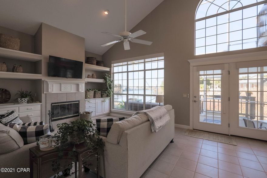 CURRENTLY UNDER CONTRACT, SELLER ACCEPTING BACKUP OFFERS - This home is a short walk 1-2 blocks to a dedicated beach. When you are done playing in the sand and sun, returning home make a quick stop at the outdoor shower for a convenient rinse before entering the house via the laundry room, and living the dream. Spectacular views inside and out from this LAKE Waterfront home! Located in the Gulf Vista subdivision on the west-end of Panama City Beach, Florida. Enjoy lake and sunset GULF views from the private balcony. Bright and sunny beach house features a living room with high ceilings, ornamented by a fireplace, built-ins, and large windows. French doors access to the wide screened enclosure back deck. A spacious kitchen flows into the dining area all with lake views. Split floor plan with two guest bedrooms on the first floor and main bedroom on the second level plus a loft that is currently used as a home office.  - All measurements are approximate, please verify if important.