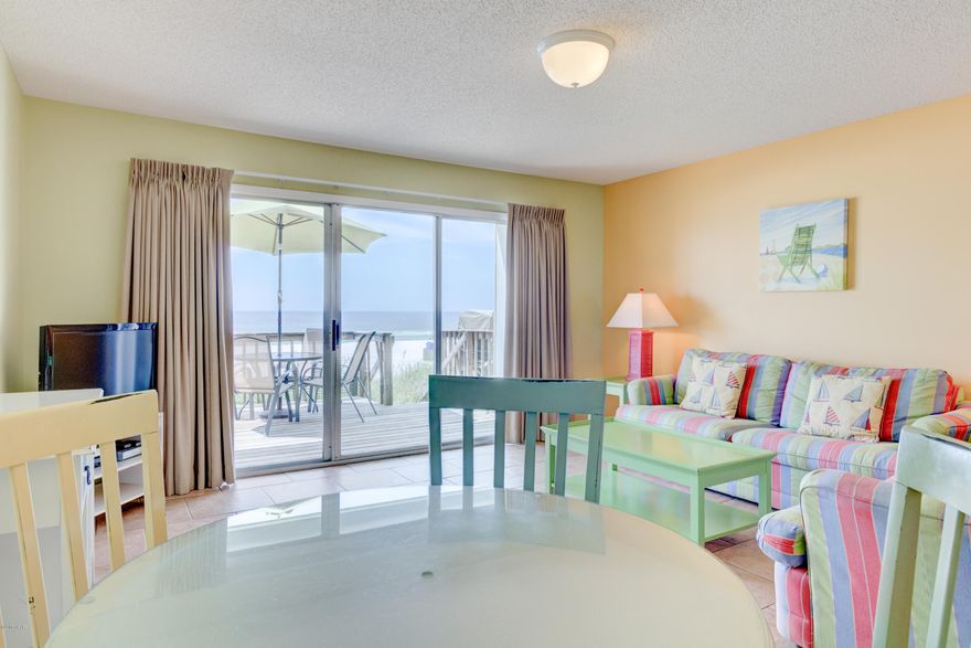 Gulf front townhome in Thomas Drive area next door to Schooner's. This 2 story, 2 bedroom and 2 bath townhome lets you park at your front door and step off the back deck directly onto the beach. No association fees.You own the unit and land (fee simple).  Rental ready. Buyer to verify all measurements if important. No Damage from Hurricane Michael.