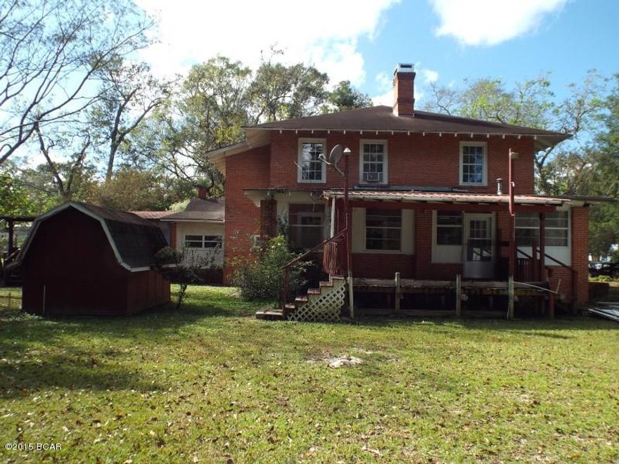 REDUCED!!! This is a very large brick two story historical house, on a large corner lot in Blountstown the house features 5 Bedrooms, 3.5 baths, 8 fireplaces and 3 porches! The house has Central Air conditioning, wall units and natural gas service.  The exterior has a large green house and carport. Sold as is.  All sizes are approximate or taken from other sources.  Please verify accordingly.