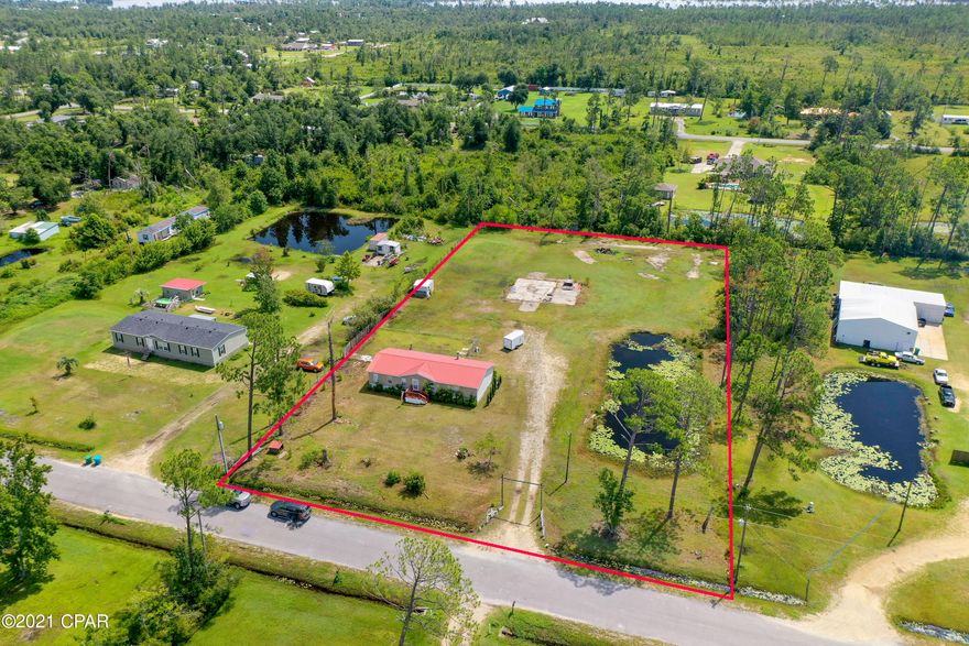 UDER CONTRACT- TAKING BACK UP OFFERS. Recently finished/renovated Kitchen!  (New Kitchen photos coming soon) 2 acres in a beautiful, quiet area of Southport. Have the benefits of the country, with the proximity to town. The lot has a large concrete foundation to build a barn, a new house, a carport, or a pole barn, complete with brand new electrical box. Fish in your own private pond. The 3 bedroom, 2 bath mobile home is mostly renovated. The interior features a roomy split floorplan, fireplace, and large master bath. New paint, and laminate flooring. The newly finished kitchen looks fresh and clean and ready for your first dinner party. All measurements are approximate, and should be verified by the buyer if important