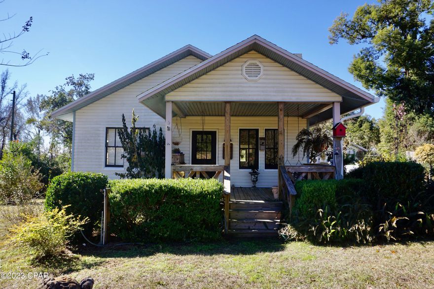 A darling cottage in quiet Chattahoochee neighborhood of Torreya Heights! This two bedroom, two bath home has been vastly updated with a completely new chef's kitchen, new doors and fixtures, and two new porches overlooking a gorgeously landscaped corner lot. Some floors, windows, electrical, and plumbing have been updated. Roof and water-heater have been recently replaced and driveway has been resurfaced. The home features a two-car garage, wood-burning fireplace, hardwood floors, plantation shutters, and beautiful custom molding throughout. The new galley-style kitchen features granite countertops, farmhouse sink, and top-of-the-line appliances, including a ZLINE professional dual fuel range. There are two large bedrooms with dedicated baths and a third room off the primary bedroom that could easily be converted into a large master closet/dressing room, nursery, office, or sitting area. Tall ceilings and many windows make this home bright and airy! Minutes from historic downtown Chattahoochee, Lake Seminole, and the Apalachicola River. A short 45 minute-drive to Tallahassee. Don't miss out; book a showing today!