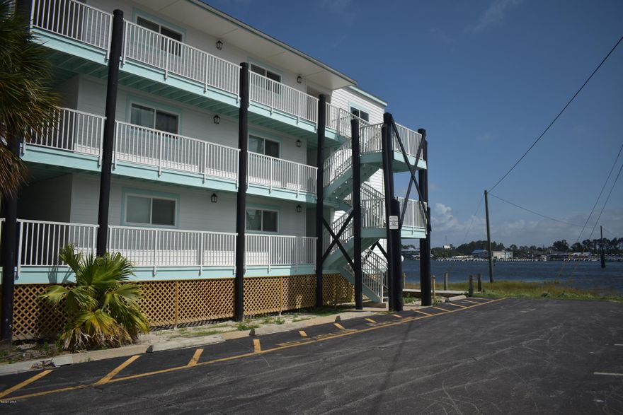 Recently remodeled lagoon front 1st floor condo. The livingroom looks out over the pool and Grand Lagoon. The kitchen has lots of cabinet space with a modern clean look and stainless appliances. The bathroom has a soaker tub with tile shower and new vanity. The bedroom is spacious with a custom closet system. In the hall is a ''halltree'' bench and cabinet area for extra storage in the condo. This unit has crown molding through out. The large balcony will be a perfect place to sit and watch the sunset over Grand Lagoon.