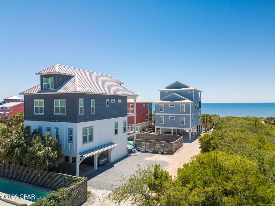First tier X FLOOD ZONE North Cape San Blas with sub-minute beach access -- no highway crossing, just a short walk over the dunes to some of the whitest sand in Florida. Ownership here means daily access to the Gulf out front and St. Joseph Bay just minutes away, where scalloping in summer, kayaking the flats, and redfish on the fly are part of the rhythm of life. T.H. Stone Memorial St. Joseph Peninsula State Park sits at the tip of the Cape, offering nine miles of protected shoreline, hiking and paddling trails, and some of the most celebrated sunsets on the Gulf Coast. This almost 3,500 sqft. gulf-view home offers 6 bedrooms, 5 baths, and comfortable sleeping for 18, making it equally suited to multi-generational ownership and strong vacation rental income for buyers seeking an investment property. The main level centers on a soaring gathering room with Gulf views, a dining area, and a gourmet kitchen featuring granite counters, stainless appliances, a walk-in pantry, and a center island seating five. The third-floor primary suite opens to a private Gulf-view deck and includes double vanities, a soaking tub, and a separate shower, with two additional bedrooms and the main laundry on the same level. A dedicated top-floor kids' retreat with three twin bunk sets, a sofa, TV, and full bath gives younger guests a space of their own. A residential elevator services the first three floors. Outside, a private 30 x 10.5 heatable pool anchors a spacious deck with sun and shade, served by a poolside kitchenette with drink fridge and ice maker. Additional features include a gas grill, fish cleaning station, enclosed outdoor shower, electronic-lock entry, and parking for five. The 8-mile Loggerhead Walk/Bike Path is at the doorstep. Bed count: 3 Kings, 1 Queen, 1 Full/Full Bunk, 3 Twin/Twin Bunks. Established rental history available on request.
