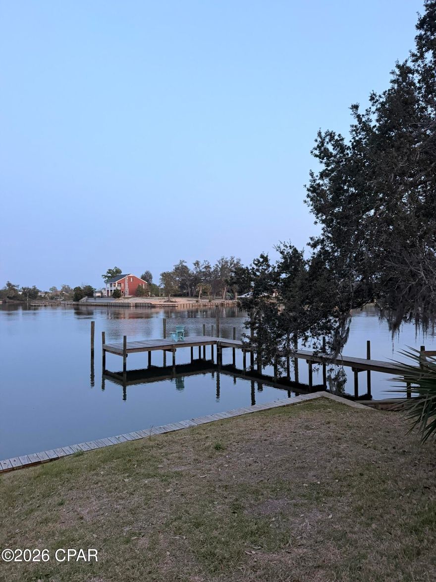 For comp purposes. Waterfront 3Bdr/2.5Bth townhome in the Panama Country Club with fantastic views of Beatty Bayou.  Kitchen opens to living area, fireplace, half bath and master bedroom and bath on first level. Second level hosts two bedrooms and a bath. Home features stainless appliances, new dock, floor to ceiling wood burning fireplace, and oversized garage.
