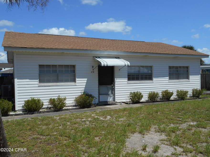 Back on market...probate complete.  Great new price too.  Located just 800' from the bay and 2200' from the Gulf, this block beach house is in need of some TLC.  It is 1170 sqft of possibilities, sitting just 1 block off of Thomas Dr.  Located on a nice 75x100 lot, this home is a blank canvas, just waiting for a new owner to custom rehab into a STR, vacation home, or a Fix & Flip.  Home has a newer roof and newer central unit.  It had been a rental for years and now needs a new family.  Meas. are approx.