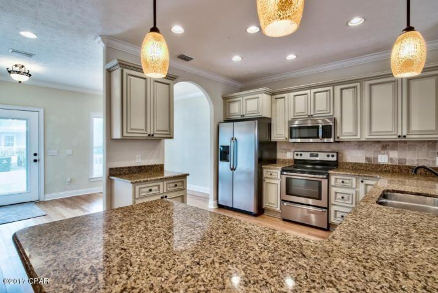 All you have to do is move in and head for the BEACH! This pre loved home has been freshly painted from the walls to the trim. Carpet professionally cleaned and both decks restained. You can find this spacious home in a quaint and quiet gated community of Paradise Grove. Located on the North side of Hwy 98 just minutes from Pier Park, WalMart and Publix. Trying to catch a flight? It's about 15 min drive to ECP airport! The Master bedroom is located on the 1st floor, has amazing tiled walk in shower, Jacuzzi tub with in line heater and granite double vanity. Kitchen has solid bamboo floors throughout, granite counter tops and custom cabinets. 2nd floor and stairs have a plush carpet. $2000 Flooring Allowance. A recreation room is large enough for a regulation pool table, wired for projector TV..watch the game on a 9 ft screen! 
Exterior features rot resistant hardi siding, maintenance free vinyl trim.
The roof has spray foam roof insulation and insulated windows - an Energy saving features! 
 Dual zone AC..set dift temp upstairs/down..electromagnetic/UV filter in AC duct..kills mold,viruses,bacteria.