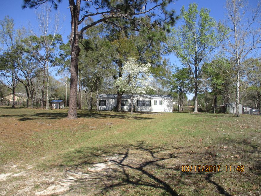 Country but only minutes to Panama City, this 3/2 double wide is a great buy featuring a large great room, dining room, fully equipped kitchen with plenty of cabinets and pantry. Split bedroom plan. Owner has updated the roof within the last 6 months, water heater, water filter system, new steps and porch. yard building wired for electricity. Completely fence 1-3/4 acres with mature trees and fruit trees. Near several boat launches and great fishing. Grocery stores and gas stations with in a mile of the property. Also restaurants in the area.