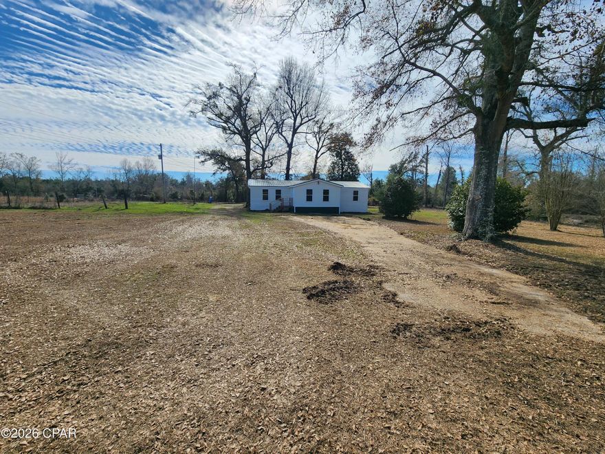 Discover Your Own Peaceful Country Retreat!
Escape to this charming 3-bedroom, 2-bathroom home nestled on a generous 5-acre parcel—the perfect blend of comfortable living and wide-open space. Imagine mornings with coffee on the expansive full-length screened-in back porch, where gentle breezes and peaceful views replace city noise. Whether you're relaxing with a book, hosting barbecues, or simply soaking in the quiet, this porch becomes your go-to outdoor sanctuary year-round—no bugs, just bliss.
The property offers incredible versatility with partial fencing ideal for pets, gardening, horses, or future expansion. Enjoy the security and convenience of two wells, providing reliable water independence for the home, irrigation, or whatever your lifestyle demands.
Inside, the thoughtfully designed layout includes an open floor plan with a bonus add-on living space featuring a raised ceiling that creates an airy, open feel. There is a large master suite with a tile shower and walk-in closet.  Recent improvements include vinyl plank flooring, vanities, interior and exterior paint,  screen and screen doors on back porch, hot water heater, and steps. A stove is soon to be included and installed.  
This isn't just a house—it's a lifestyle upgrade on rare acreage, offering privacy, room to roam, and endless possibilities. Whether you're seeking a forever home, a hobby farm starter, or a serene escape from the everyday hustle, this property delivers space, serenity, and value.
Call today to schedule a showing to your new home.