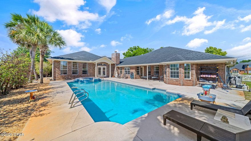 Executive canal-front estate in the highly sought-after Kings Point community offering direct access to St. Andrews Bay and the Gulf of Mexico. This exceptional waterfront property combines luxury, functionality, and true Florida coastal living with a private dock, 10,000 lb boat lift, and seawall, designed for effortless boating and fishing right from your backyard. With no HOA restrictions, the property offers rare flexibility and freedom in a premier waterfront location.

Inside, the home showcases an expansive and thoughtfully designed split-bedroom floor plan featuring 5 bedrooms, a dedicated office, formal dining room, and multiple living and entertaining spaces. The main living area is anchored by a spacious family room with fireplace and seamless flow into the kitchen, creating an ideal layout for both everyday living and entertaining.

The gourmet kitchen is appointed with quartz countertops, stainless steel appliances, a breakfast bar, and ample cabinetry, blending style and practicality. Natural light and open sightlines enhance the main living spaces, making the home feel bright, open, and inviting throughout.

The primary suite serves as a private retreat, featuring a bay window overlooking the property and a well-appointed en-suite bath complete with a deep garden tub with built-in speakers, separate walk-in shower, dual vanity, and a spacious walk-in closet. The design emphasizes comfort, privacy, and relaxation.

Designed with entertainment in mind, the home includes an expansive bonus entertainment room featuring a built-in bar with sink and wine refrigerator, perfect for hosting gatherings. A dedicated theater room with surround sound delivers a true cinematic experience. Additionally, a separate mother-in-law or guest suite with private entrance provides exceptional flexibility for extended family, visitors, or multi-generational living arrangements.

Outdoor living is equally impressive, featuring a saltwater pool and hot tub overlooking the canal, creating a private waterfront oasis ideal for relaxing or entertaining. The backyard offers direct Gulf access, complemented by a private dock, boat lift, and seawall, making it a true boater's paradise. A full lawn sprinkler system supports easy maintenance of the landscaping.

Additional upgrades and features include a surround sound system throughout key living areas and a transferable termite bond with Terminix (renewal date 5/31/2026), providing added peace of mind for the future homeowner. The property is also conveniently located near hospitals, shopping, dining, and major conveniences while still maintaining a quiet waterfront setting.

This rare offering delivers an outstanding combination of space, privacy, luxury amenities, and direct waterfront access. With its versatile layout, resort-style outdoor living, and premier boating capabilities, this Kings Point estate is perfectly suited for both full-time residence and exceptional entertaining.