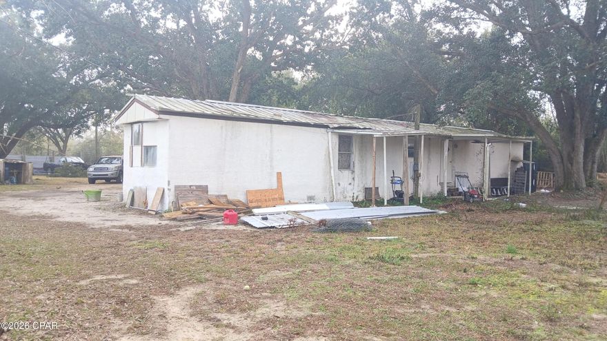 2-bedroom, 2-bath mobile home with solid flooring installed. One side of the home is more livable than the other. Flooring installation was started in the master bedroom but needs to be redone. Property needs a new roof. Window AC units only. On well water; electricity and plumbing are in good working condition. Renovations needed include roof, master bedroom, well filtration, and back porch.