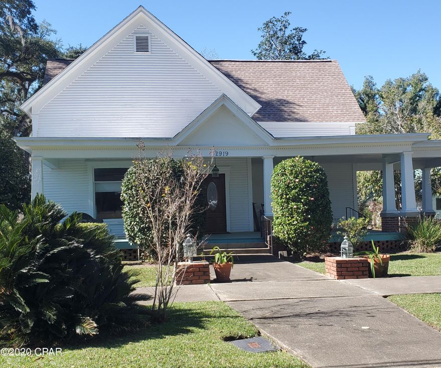 Located in Marianna's Historical Downtown, this beautiful turn of the century home is said to be built in 1910. The rocking chair front porch, huge leaded glass windows, 12 ft ceilings, hardwood floors, 5 gas fireplaces, bring bring out the historic character. Within the last 2 years, the home has had extensively updated and remodeled including electrical, plumbing, bathrooms, 2 new H/C units (one electric heat pump, the other natural gas heat), totally remodeled kitchen with granite counter tops, stainless appliances and new cabinets.  Need a Home Office with separate entrance? This home is zoned for that!  Beautifully landscaped there is also a separate building that can be updated for a shop or guest house. This home is a Must See!