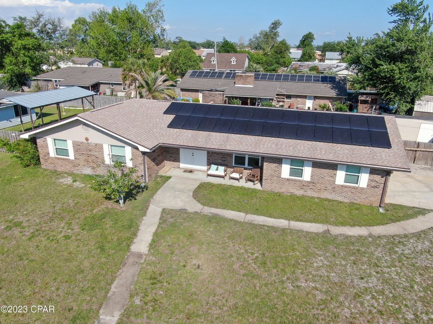 'CURRENTLY UNDER CONTRACT, SELLER WILL CONSIDER BACKUP OFFERSBRICK 3 Bedroom/2 bath home on a LARGE corner lot conveniently located just off 390 near schools, shopping, restaurants and more! Featuring luxury vinyl plank flooring throughout all common areas and bedrooms; Large living room with a wood-burning fireplace; formal dining room and spacious kitchen featuring quartz countertops, pantry and tile flooring leading to the laundry room. Laundry room features  a built-in collar activated motor driven pet door and 2 car garage. Master bedroom features a walk-in closet, and tub/shower combo. Exterior showcases a 28x11 screened in back patio, 2 sheds - one equipped with electrical, additional storage area in garage, privacy fenced and solar panels. Schedule your private showing today! All measurements approx buyer to verify if important