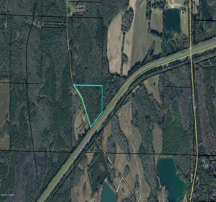 15.71 Vacant land.  Wooded with hardwoods and pines. Some low lying. About 700 ft. frontage on 1-10 and county maintained road. About a mile to US Hwy 90. Short distance to Panamc City International Airport and the world's most beautiful beaches.  This is a great investment with a price you can't go wrong.