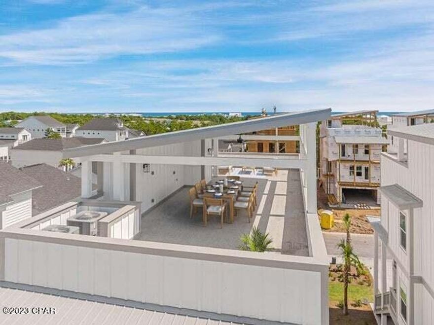 New Brock built home with a contemporary flair is the only resale available in Twin Palms in Inlet Beach, less than a mile to multiple beach accesses.The three story linear beach home features a downstairs ensuite space that could accommodate a bunk room and flows into a flex space with built-in seat bench. Conveniently leading to the ground level oversized garage with room for two cars and a golf cart or gym with shower. As you ascend the stairs you are greeted by sleek finishes with touches of white and black. The floor plan flows with a a built-in office nook, dining area, center island white quartzite, and an additional gathering space with a dynamic black statement wall featuring a linear gas fireplace.