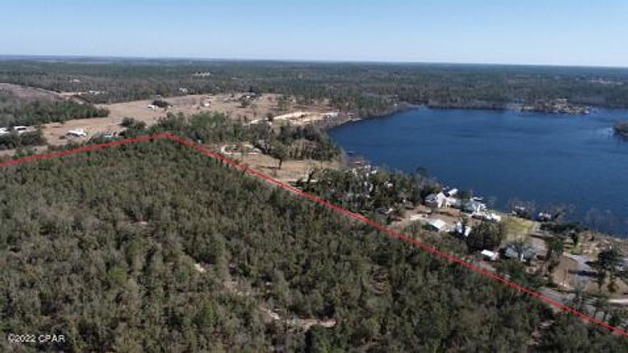 25.4 acres across the street from beautiful Compass Lake located in northwest Florida. This property is wooded and could be the perfect location for your dream home. Homes in Compass Lake in the Hills have access to the clubhouse and amenities that include, swimming pool, tennis courts, picnic areas, fishing, etc. There are two public boat ramps just across the street from this property.  Compass lake is the perfect place for fishing, boating, water sports, swimming, and relaxing enjoying the beautiful views. This lake is busy with motorboats in the summer, but a private oasis in the off season with almost still water reflecting the skies. The lake is a sandy bottom and has clear water. The lake is located almost equal distance from the beaches of Panama City and Dothan, AL.