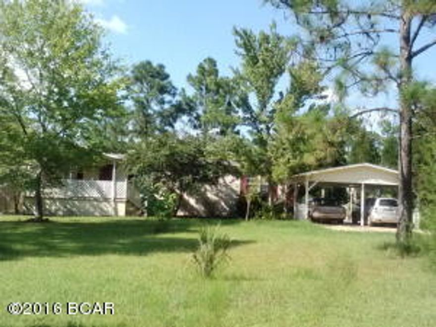 Country living at its best, on this 7.58 acre parcel with a beautiful Doublewide Mobile home and in ground pool. This home is VERY nice, has been totally redone inside to look like a site built home. New cabinets,hardwood flooring and all wood trim. Home has 3 bedrooms and 2 full baths,fireplace in the large den that opens into a nice size hobby room or office area. Living area and formal dining is at the front of home, master bedroom has shower and large garden tub, double vanity off the den. Kitchen has a bar and dining area off the end of home that opens to a fenced patio. Detached double carport and 2 storage buildings , pump house and all types of flowering plants around home. Large covered front porch too. This is a great property