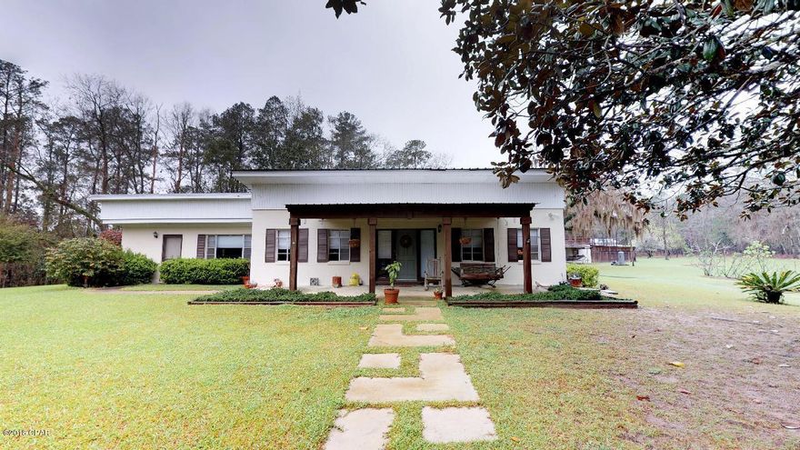 This lush 10 acre property has so much to offer with mature fruit trees, 2 plums, 1 pomegranate, 2 grapefruit, 2 meyers lemons, 2 satsumas, pecans, figs and cypress. There is a refreshing pool,  and wired workshop with bays and a yard building. There are two septic tanks on the property and well that needs a new pump, however, the house is connected to city water. The acreage offers much to be desired, but it doesn't stop there. The home has a newer roof of less than three years, extra space with a mudroom and sun room.  The home has laminate and tile with no carpet. The master bedroom offers a walk-in closest, double vanity and tile shower. The split floor plan makes for a great design. The beautiful quartz kitchen island offers plenty of room for cooking. This is a must see~