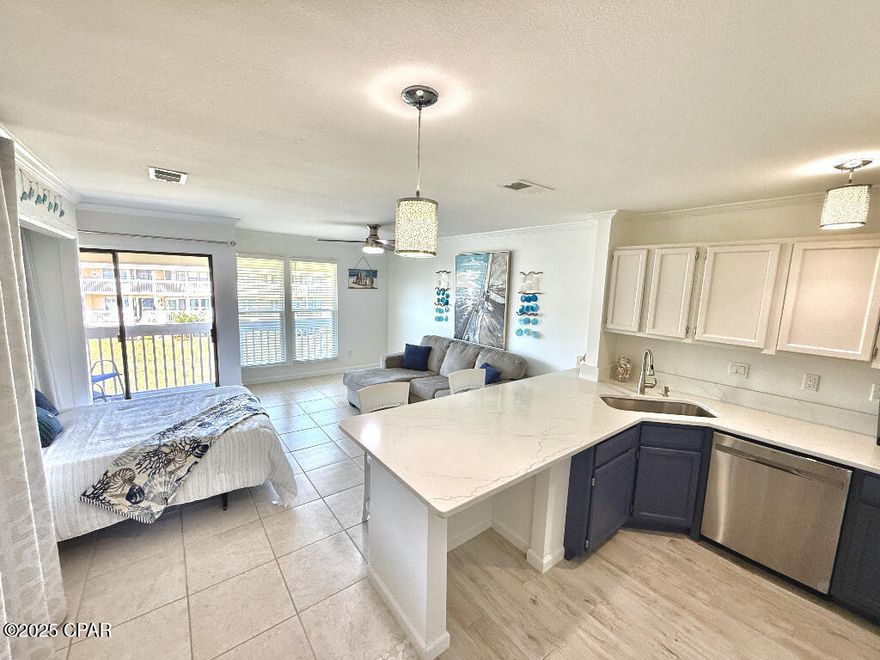 Stunning updated second floor studio condo in the unique Sandpiper Cove gated resort in Destin boasts a full-sized kitchen and a queen murphy bed which folds up during the day for extra space. In 2022 around $20,000 in updates were completed which include: quartz kitchen counters, farmhouse sink and faucet, stainless dishwasher, stainless oven, stainless microwave, painted kitchen cabinets, light fixtures and ceiling fan, hot water heater, Pella hurricane impact windows, window blinds, washer and dryer hookup and appliances (which is not common in the studio units), bathroom vanity, tub/shower surround, toilet, and gorgeous faux wood tile installed in the entry, bathroom, kitchen, and closet. From the front door you can see the ocean across the street where you will have access to Sandpiper's private beach that spans 1100ft along with a seasonal beach snack bar all within walking distance. At the beach, you will have the option for beach chair rental service for guests and owners. This property includes access to an on-site boat ramp on the harbor, canal boat parking is available, 5 swimming pools (2 are heated), 3 hot tubs, Par-3 9-hole golf course, 3 tennis courts, 8 pickleball courts, near the boat ramp/marina a fish cleaning station, Louisiana Lagniappe year-round restaurant on the harbor, and an Event Center that can be reserved for a variety of events. There's not another community like this in Destin that has the best of both the harbor and the beach, along with all the amenities that you'll enjoy here, and it's right in the heart of Destin close to shopping, restaurants, parks, and amusements! People love taking a water taxi from Sandpiper to the Harborwalk Village as well! Whether you're looking for a low maintenance place to live or interested in owning a short-term rental, or perhaps looking for a 2nd home, this beautiful community has been a favorite for many for decades! Once you experience it, you'll see for yourself!