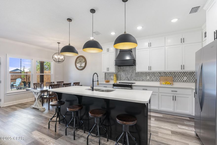 SELLER MOTIVATED with flexible terms available. Conveniently located in central Panama City, this property offers quick access to Tyndall Air Force Base, is just minutes from major shopping and dining along 23rd Street and the Panama City Mall area, close to HCA Florida Gulf Coast Hospital and other medical facilities, and only a short drive to the beaches of Panama City Beach and local coastal attractions.

Outlaw built in 2022, this quality home features custom finishes and thoughtful attention to detail throughout. With 4 bedrooms and 2 full bathrooms, the 4th bedroom includes double doors and can easily be used as a home office.

Enjoy 9' ceilings and an open layout. The kitchen offers custom cabinetry extending to the ceiling, quartz countertops, a large island, luxury tile backsplash, a walk-in pantry, and upgraded stainless steel appliances including a refrigerator. The main living area features crown molding, and the Great Room includes a tray ceiling with additional crown detail.

The main suite includes a double cultured marble vanity, garden tub, separate cultured marble shower with seat, and a spacious walk-in closet. French doors with built-in blinds open to a large covered porch overlooking a landscaped yard with sprinkler system, fruit trees, and a shed.

Additional upgrades include waterproof vinyl plank flooring throughout, LED recessed lighting, upgraded fixtures with ceiling fans, and a garage wired for electric vehicle charging.

Assumable VA Loan available for qualified buyers — an excellent opportunity to take advantage of potential lower rates.