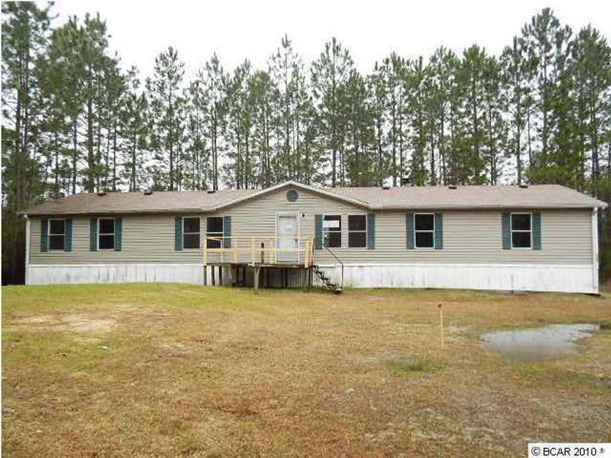 Privately located doublewide sits on a little more than 1/2 acre and offers a large interior that includes formal living and dining rooms, a split planned master suite w/full bathroom, family room w/wood burning fireplace, kitchen w/all appliances, and 3 additional bedrooms w/reach-in closets. Bring the boat! This home is blocks from Deer Point Lake, Gainer Bayou, and the North Bay with multiple boat ramps nearby! Plus, this home offers excellent proximity to Southport, Lynn Haven, and Gulf State College! EQUAL HOUSING OPPORTUNITY.