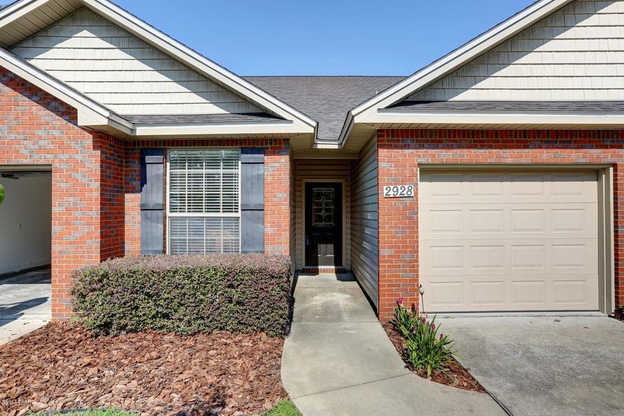 100% FINANCING AVAILABLE IN LYNN HAVEN SCHOOL DISTRICT! Excellent price and location for one of the more upscale units in Palmetto Ridge! This well maintained home offers an open floor plan with a breakfast bar and stainless appliances, downstairs master bedroom with separate shower, tub and walk in closet!! Upstairs you will find 2 bedrooms and bonus room with over 200sqft of attic storage space! Another great feature of this home is the half bath near the living room for your guests. Exterior features an attached garage, extra parking for guests nearby, brick and vinyl siding, covered patio and sodded yard with a sprinkle system! You cannot beat this location, call today!