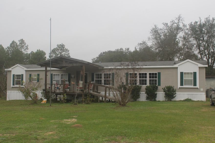 HIDDEN GEM! This newer 3 bedroom, 2 bath manufactured home by Waverly is situated on almost 2 acres (see survey) in a very peaceful and quiet area.  Enjoy fishing for bream or kayaking in part of Cedar Creek.  Sit on the large covered porch out front with your coffee.  The inside of this home is very open and spacious with crown molding throughout. It features a stone fireplace with recessed lighting and built in cabinets in the den. It also has a flexroom for an office. The kitchen offers an island and bar with extra cabinet storage along with stainless steel refrigerator, stove/oven/microwave and pantry.  The dining and living room adjoin for entertaining.  Master bedroom is located on one side of home for privacy and master bath features a large garden tub, separate shower and double vanity.  Each bedroom has walk-in closets.  The fenced backyard already has a garden full of vegetables!  This land is actually two lots with a possibility of adding another home.