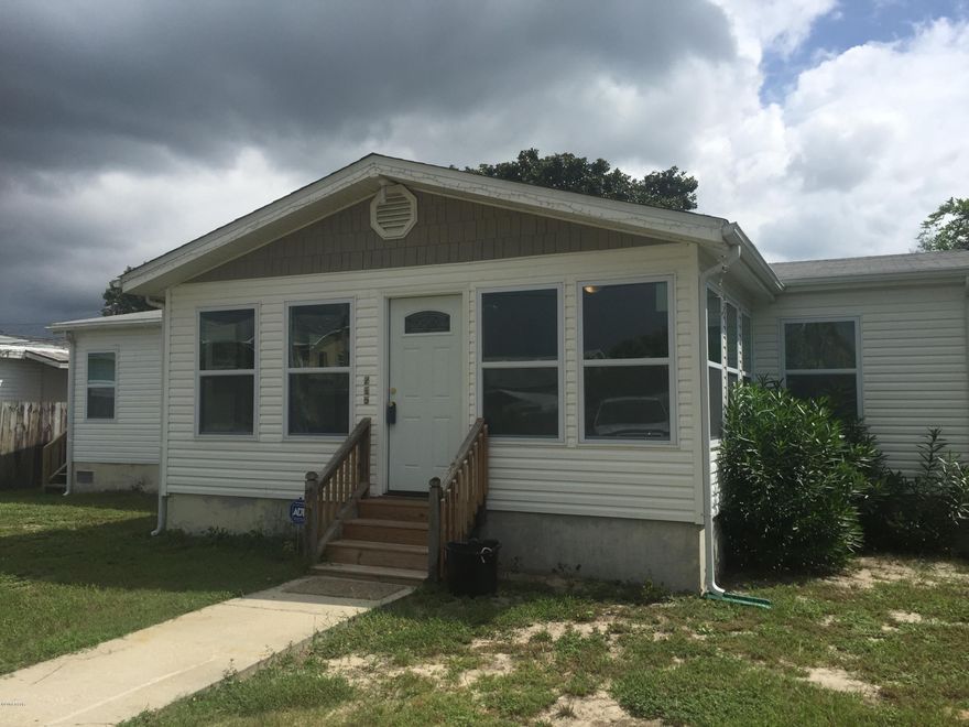 This is a great investment opportunity.  Only approximately 4 blocks to the Gulf.  This is a unique manufactured Home with a 12x20 Florida Room built on the front, and an extra room 9x10 built on the back.  also has an 8x12 wooden built deck on the back. The Florida room has vinyl windows, paneled doors and an ornamental door on front.  Most of the back wall of the home has been replaced with a house built wall.  The windows inside the home has been replaced with vinyl windows and doors have been replaced with paneled doors.  Large Living and Dining area with vaulted ceilings. This home can be converted to sleep up to 10 people with out any additions. There is new carpet and new painted rooms through out home. New kitchen appliances. This is a must see home.