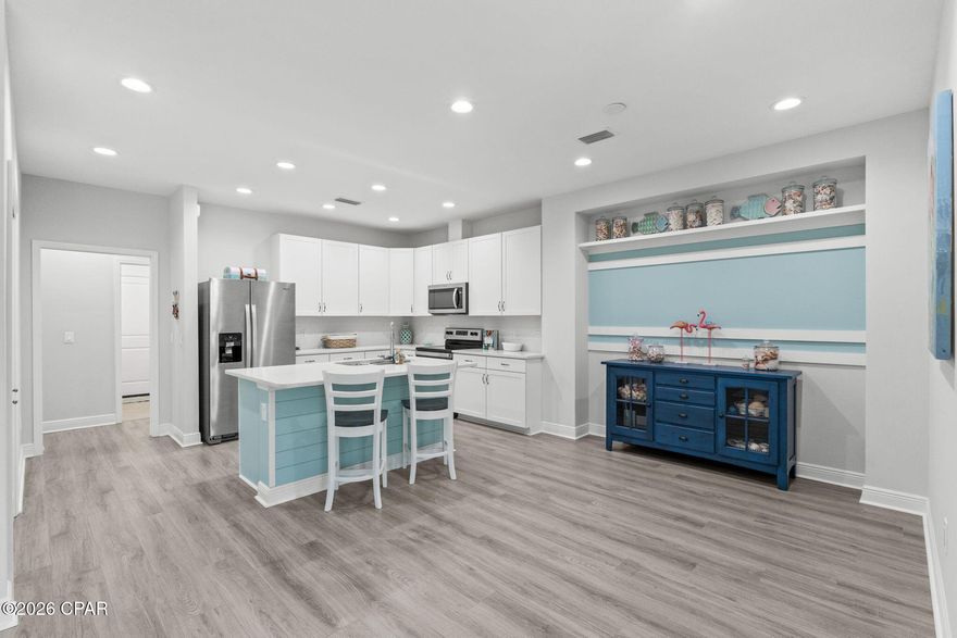 Welcome to this beautifully upgraded ANTIGUA model located in the coveted Phase 3 of Latitude Margaritaville Watersound, just a short golf cart ride to Town Square where the music, events, and daily activities keep the Margaritaville lifestyle buzzing.
This light, bright, and airy home blends coastal charm with thoughtful upgrades designed for easy, resort-style living. The open-concept layout features recessed lighting throughout every room, including the dining room, along with ceiling fans in the great room, primary bedroom, and guest bedroom to enhance comfort and keep the breezy vibe flowing. The stylish kitchen is beautifully appointed with quartz countertops throughout, a glossy white subway tile backsplash, and 42'' white cabinetry with soft-close doors and drawers, complemented by stainless steel Whirlpool appliances including a side-by-side refrigerator and electric range. A flex room provides the perfect space for a home office, hobby room, or additional bedroom for visiting guests.
The home continues to impress with upgraded laminate flooring throughout, upgraded 5¼'' baseboards, and whole-house 2'' faux wood blinds, creating a clean and cohesive look. Custom wall detailing in the primary bedroom and dining room add an extra touch of character, while the primary bath features an upgraded shower with floor-to-ceiling tile for a spa-like feel. Practical touches include a Whirlpool washer and dryer and a garage utility sink for added convenience.
Step outside and enjoy the extended patio, where half is covered by a screened-in lanai, creating the perfect space for relaxing with morning coffee or evening cocktails while enjoying the Florida breeze.
Life in Latitude Margaritaville Watersound revolves around the vibrant Town Square, the heart of the community where neighbors gather, music fills the air, and every day feels like a celebration. At its center is the stunning Paradise Pool, a resort-style oasis with sparkling waters, shady tiki huts, and plenty of space to relax while visiting with neighbors. Residents enjoy an unmatched amenity lineup, including an indoor lap pool, a state-of-the-art fitness center, spa services, pickle ball, tennis and basketball courts, miles of walking and golf-cart trails, a kayak launch, and lush green spaces. Entertainment thrives at the Last Mango Theater, while creative spaces like the 'Clayground' pottery studio and woodworking shop offer opportunities to learn, create, and connect. Even four-legged family members are pampered with an on-site pet groomer and the popular Barkaritaville Dog Park. Live music, outdoor activities and a lively monthly farmer's market bring island energy right to your doorstep, and best of all, no yard maintenance; with the HOA covering exterior painting and roof replacement. That means more time to relax and enjoy the good life. Just outside the neighborhood, convenience continues with a new Publix grocery store currently breaking ground, additional retail coming soon, including a pizzeria, a future marina under development, and a new hospital being built nearby for easy access to top-tier medical care.  The future hospital, being developed in cooperation with Florida State University and Tallahassee Memorial Health Care, is slated to open in 2027 and will bring first-class healthcare to the area. In Margaritaville, everything you need: fun, relaxation, convenience, and community is right at your fingertips. With shopping, dining, and entertainment just moments away, this home offers the perfect blend of luxury, convenience, and island inspired living, just bring your flip-flops! Golf cart negotiable. 
Come experience the fun, relaxed, and resort-style living that makes Latitude Margaritaville Watersound so special. 🍹🏝️