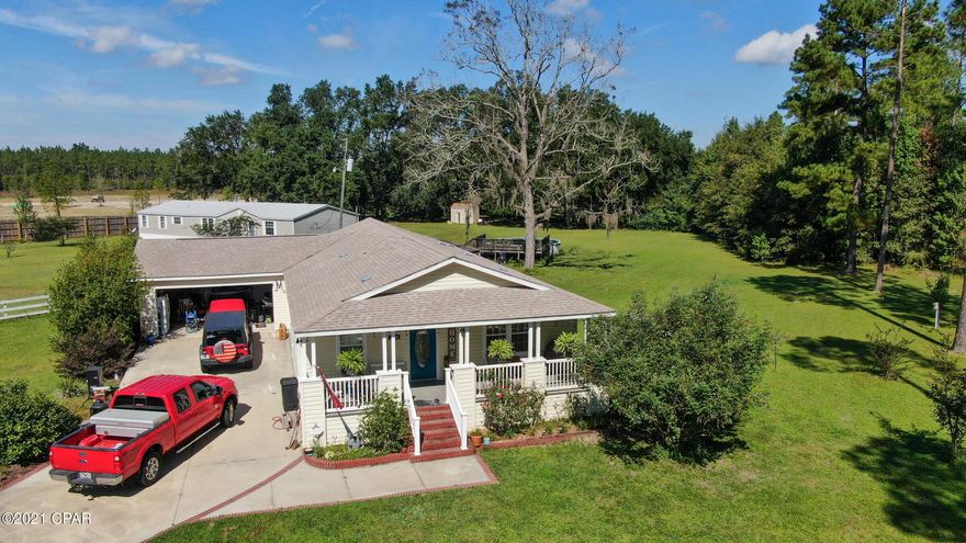 CURRENTLY UNDER CONTRACT, SELLER ACCEPTING BACKUP OFFERS. Beautiful country home on 13.4 acres! This modular home is located just 30 minutes north of Panama City Beach and features open & spacious rooms, breakfast bar, crown molding throughout,  huge closets, great landscaping,  and composite decking covered front porch. There is a shed and a large above ground pool with decking.  The property is huge! More than enough room to build a workshop or carve some off and sell.  All measurements are approximate, verify if important.