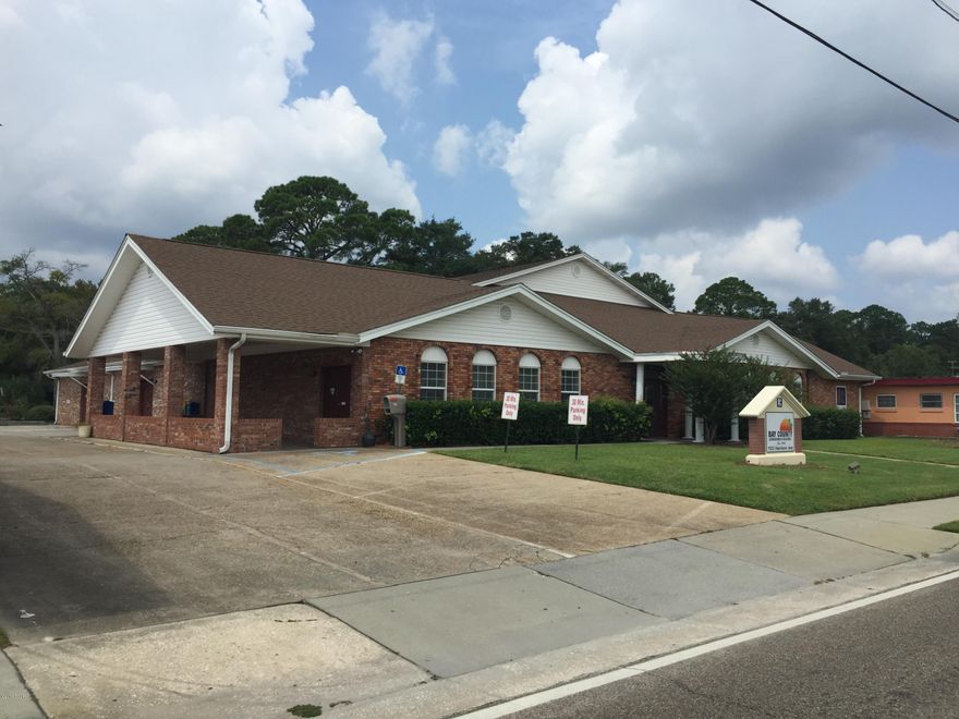 123 Harrison Avenue is a 10,000 +/- sf brick and concrete block professional office building. The building possess 8,905 +/- sf of office space on the ground floor and approximately 1,978 +/- sf on the second story. The current configuration of the ground floor includes: 9 offices, one large conference room, one small conference room an executive board room, glass front reception and seating/ waiting area, four restrooms (2 handicapped accessible) and a full kitchen. 1123 Harrison Avenue has received major renovations and updates with the most recent occurring in 2008. The second story is currently in unfinished condition for storage needs or could be built out for additional office space. The property benefits from ample parking opportunities including 60 +/- delineated asphalt and concrete surface parking spaces. Also, a .46 +/- acre vacant commercial parcel located at the northwest corner of 11th Street and Grace Avenue is included in this sale offering. The subject property is located on the west side of Harrison Avenue, south of Hwy 98 (aka 15th Street) & north of 11th Street. The property possesses 125' of frontage along Harrison Avenue. The site is centrally located between the area's two hospitals, Gulf Coast Medical Center and Bay Medical Sacred Heart. In addition, the subject property is located approximately a 1/2 of a mile south of Hwy 98, the area's major east/west commercial corridor and at the gateway to downtown Panama City. Notable major landmarks in the vicinity are Bay High School, Panama City City Hall, Bay County Government Center, Bay County Courthouse and the Bay County Chamber of Commerce. 1123 Harrison Avenue is located at the heart of Panama City, is easily accessible and convenient to area businesses medical and government installations.