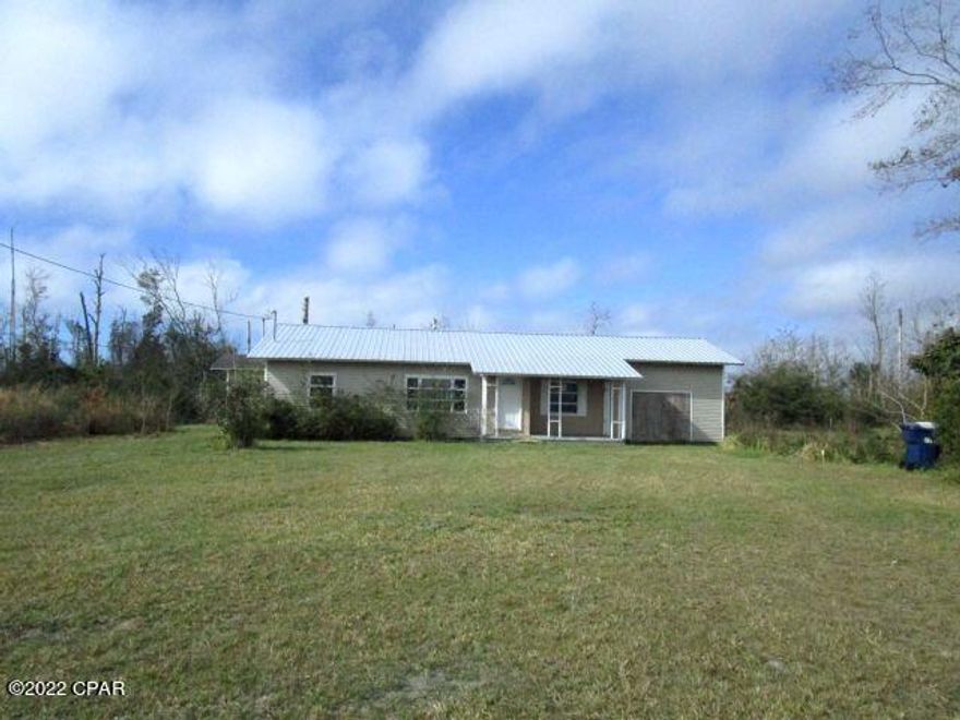 Loads of possibilities are found in this three bedroom home on over two acres.  The home did receive damage during the hurricane, but the roof appears to be in good condition (age unknown), and it is ready for a complete remodel and your personal touch!!   Situated within a short drive to Tyndall AFB, enjoy the feel of country living within a close drive to shopping and schools.  This home has so much potential!