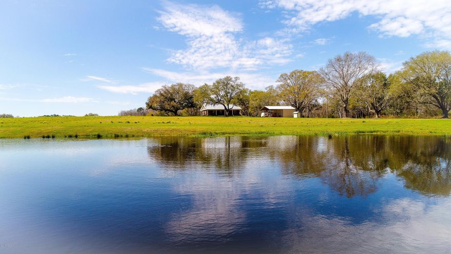 NEW 3/2 (1600sqft) Home built for the Country! As you travel down the winding drive you will find the perfect home nestled among Live Oaks and overlooking a picturesque pond. The privacy is only out matched by the craftsmanship of this home built in August 2017. Too many custom upgrades to list but everything and more for your new Country Life! Complimented by 48x32 w/approx 738sqft of climate controlled living space (with full bath), over 90ac of crop land and apporx 6ac of Timber. Wildlife will be your only Neighbor! Call today for your guided tour!