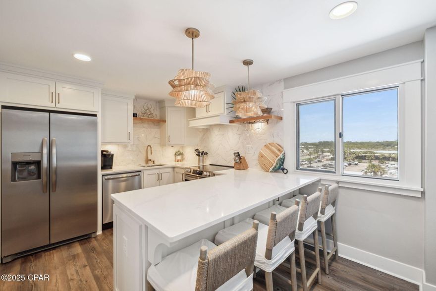 Perched within the gated Gulf-front community of Pinnacle Port, this two-story condo enjoys one of the most unique vantage points on the coast: framed by the Gulf of Mexico on one side and Lake Powell, Florida's largest coastal dune lake, on the other.

From the moment you step inside, sunlight fills the open, modern interior where water views become part of the backdrop to daily living. An entry closet stocked with beach essentials - chairs, umbrella, and cooler - keeps coastal days effortless.

The first floor offers an airy open-concept living and dining space with balcony access taking full advantage of the water views of Lake Powell. A dedicated workspace makes it easy to stay connected while embracing the coast. Upstairs, the primary suite offers a queen-size bed, two separate closets, an en-suite bath with a full tub/shower combo, and a private balcony that opens to sweeping Gulf views. The second bedroom comfortably sleeps four with two twin beds plus twin bunk beds and has access to a hallway bath with a walk-in shower.

Pinnacle Port's resort-style amenities include two swimming pools, four lighted tennis courts, shuffleboard, bocce ball, basketball, a fitness center, grill and picnic areas, and plentiful boating options with a boat ramp, slips, trailer parking, a fishing pier, and kayak access. Just three miles from the boutiques and restaurants of Scenic 30A, close to Publix, and only a short drive to Pier Park, this property combines a rare waterfront setting with convenience and coastal style.