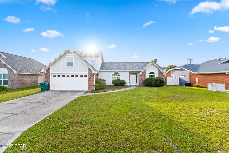 Set on a generous 0.26-acre lot in Colonial Estates, this 4-bedroom, 3-bath home offers 2,317 sq ft of easy, everyday living. A welcoming foyer opens to a fireplace great room and a true dining room, with a second casual dining space off the kitchen for weeknight meals. The split layout places the primary suite on the main level with two closets and a spacious bath featuring dual vanities, a soaking/jetted tub, and separate shower. Two additional main-level bedrooms share a full bath, while an oversized upstairs bedroom with its own full bath makes an ideal guest suite, teen retreat, or home office. Interior highlights include raised ceilings, skylights, a breakfast bar, and an inside laundry. Outside, enjoy an open patio, a fenced backyard for play or pets, and an attached 2-car garage with driveway parking.

Location puts you close to everyday conveniences along Tyndall Parkway, minutes to Tyndall AFB, and an easy drive to downtown Panama City, waterfront dining in Historic St. Andrews, local marinas and boat ramps on East Bay, Parker Sports Complex, and area parks and beaches—plenty to do when you're not relaxing at home. Present zoning is Residential Single Family; short-term rentals are allowed per listing details.