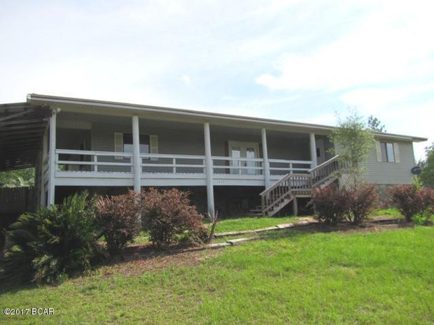 INVESTORS DREAM !! LESS THAN $ 20 per sq ft BARGAIN  !! A Huge Home (4,000+ sq ft)on a Big Double (2+ Acre)Corner Lot in need of renovation. Owner too busy with other projects, so says SELL IT AS IS. Huge Open Family Room/Dining/Kitchen with Stone Fireplace, Master Suite with Fireplace, Guest Bedroom and Full Bath, Laundry, and Screen Patio/Tiki Bar all on main entry level. 4 Bedrooms, Full Bath, Rec Room with Fireplace, and Kitchen area downstairs. 20' x 38' Carport with minimum 12' height clearance provides parking for RV and cars. All conveniently located in the Compass Lake in the Hills Subdivision in desirable NorthWest Florida. Just 15 minutes South of Interstate 10 and 40 minutes North of Panama City. Amenities include Lake, Swimming Pool, Tennis Courts, Horseback Riding, etc.