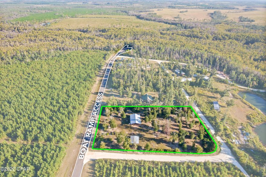 This would make for an ideal FISH CAMP! This property is in a great rural area with plenty of fishing, Cypress Creek Public Boat Launch is 0.1 miles from the property which makes it just minutes away from World Class freshwater fishing on the Dead Lakes, Chipola and Apalachicola Rivers. A short drive to Port St Joe and Mexico Beach where you can enjoy saltwater fishing in the Gulf of Mexico or take a stroll along the white sandy beaches. RV approved with a 30-amp and 50-amp hookup, well and power in place. Septic needed. Property improvements include 36x50 engineered plan pole barn, screened in outdoor kitchen with lean-to for boat or covered porch. Property has a variety of fruit trees and shade trees. Property is X flood zone. Mailbox address is: 2791 SE Nadine Stone Landing Road, Wewahitchka, FL 3244