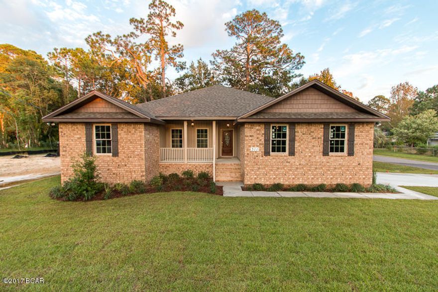 Here it is! Top notch construction, high end finishes, and custom feel quality at an affordable price. This all brick, 4 bedroom, 2.5 bath home is situated on a corner lot in the heart of Lynn Haven, with beautiful views of the bayou across the street. This oversized corner lot is perfect if you have a boat, jet skis, or just want a great size yard! The detail and upgrades throughout the home are noticeable the moment you walk. Want hard wood floors, but hate scratching them up? You’ll love this tile in the foyer and living room. Also, this floor plan is one of the best you’ll see. The openness, high ceilings, and amount of natural light make it feel even larger. Custom cabinets in the kitchen and bathrooms, along with upgraded granite in the kitchen, and cultured marble in the bathrooms are just one of the other upgrades you'll find. The master bedroom/bathroom suite are perfect; with double sinks, a separate tiled shower and whirlpool tub, 2 huge walk-in closets, plus a separate toilet. If you weren't in love by now, you will be after viewing this master suite! We can easily supply you with a list of other upgrades and finishes upon request. Call today!
