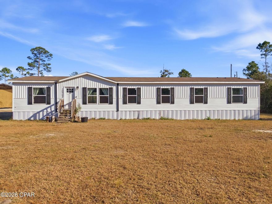 Welcome to your private homestead! A beautifully maintained 4-bed, 3-bath residence nestled on a generous 10-acre tract just minutes from US-231 and within easy reach of Panama City. Built in 2021, this distinctive home offers an expansive 2,430+ sq ft open layout designed for comfortable everyday living and unforgettable gatherings. BONUS: Seller is offering $5,000 in Closing Cost Credit with a Strong Offer!

Step inside and be greeted by light-filled spaces and thoughtful flow between living, dining, and kitchen areas - ideal for both everyday life and entertaining. Four well-proportioned bedrooms, two bonus areas, and three full baths provide flexibility for guests or a dedicated home office. 

What truly sets this property apart is the exceptional outdoor space. With 10 acres of versatile land, you have endless possibilities. Think hobby farming, equestrian pursuits, recreational vehicles, gardens, or simply peace and space to call your own. A newly installed concrete-slab pole barn expands your storage and workshop options - perfect for tractors, toys, tools, a covered entertaining space or creative projects. 

Additional features include:
• Private well and septic utilities in place
• Ample parking and outdoor space for RV/boat storage
• Quiet rural setting with convenient access to local amenities
• Room for future enhancements or agricultural pursuits

Embrace the rare combination of serene country living within a close proximity to city conveniences and the World's Most Beautiful Beaches. This property offers a lifestyle opportunity - not just a home!