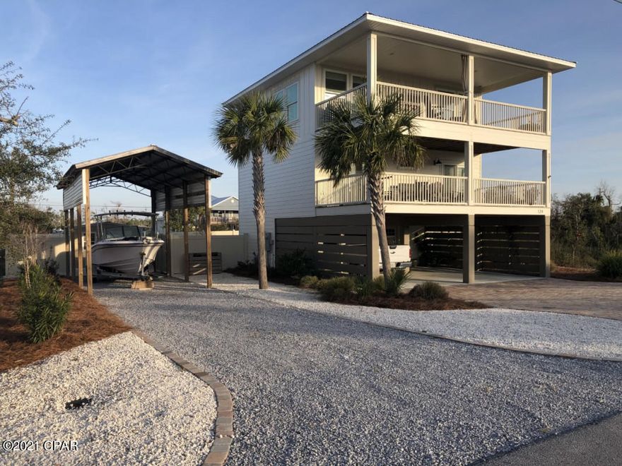 Enjoy warm gulf breezes and water/sunset views? Then this is the beach house for you! Two 30x12 covered decks face west, just one block off the dedicated beach on ''The Bluff'' (high ground/X flood). You're steps away from a walking path to a beach boardwalk!  This stunning, spotless 2018 home boasts 2070 square feet (with 720 more from decks), a tall boat/RV barn and shed for toys, metal roof, James Hardiboard siding, a large paver driveway, and vinyl fenced, landscaped backyard with room for a pool. Enjoy CoreTec vinyl flooring and the landscape well pump that waters every plant automatically- no grass to mow! The kitchen sparkles with quartz counters, granite sink, LG Studio appliances, gas range, and self-closing cabinets. Energy star hurricane-rated windows and sliders. Expansive great room with vaulted ceiling and spacious dining room. Too many extras to mention. This home is move-in ready!  Don't wait to see it, this beach house will go fast!