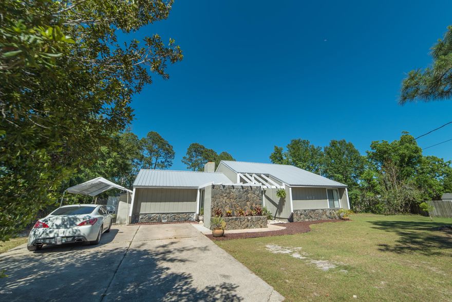 Don't miss this fantastic opportunity to be in the heart of Panama City for under $200K! Brand new luxury vinyl tile and carpet just installed in entire home, a newly painted interior, and a metal roof that's only 5 years old! Just blocks away from all the best shopping, dining, and medical facilities, this 4 bedroom home located on a cul-de-sac is perfect for your family. The backyard is massive! Enjoy the screened porch on a hot day and the fire pit for cooler evenings and entertainment. There's a grilling area, two storage buildings, and delicious wild grapes! With all that, there's still plenty of room for a pool! Newly painted interior with popular, modern color scheme and stainless steel kitchen appliances.  Sellers say to bring all offers