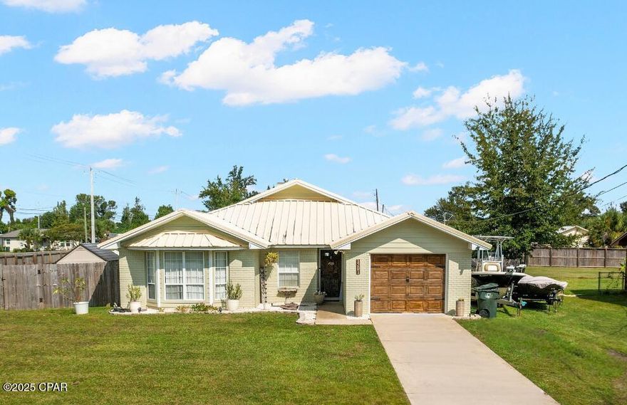 CURRENTLY UNDER CONTRACT, SELLER WILL CONSIDER BACKUP OFFERS. Welcome to the cutest home on the block!
1201 Pennsylvania Ave is a charming 3-bedroom, 2-bathroom home located in the heart of Lynn Haven (huge corner lot), offering a blend of modern upgrades and classic charm. 
Don't let its size fool you—this home is more spacious than it appears and has been thoughtfully updated for comfortable living.
The home features a smart split-bedroom floor plan that provides privacy for everyone when its needed. The primary suite is functional and stylish with tray ceiling, LVP flooring, and two closets, complemented by a spacious private en-suite bathroom, that is also pretty roomy. 
On the other side, two good size guest bedrooms share a full bathroom with a shower/tub combo and a cute skylight that fills the space with natural light.
The main living area is simply charming. Vaulted ceilings, authentic hardwood floors, and a cozy wood-burning fireplace create an inviting atmosphere. The kitchen is a bright and happy space, filled with natural light from a skylight and featuring a breakfast nook—a perfect spot to gather while enjoying a view of the incredible backyard.
Speaking of the backyard, it's huge! A wonderful enclosed patio provides a great transition to this space, which is perfect for future pool and playground, or for simply enjoying the beautiful pergola that the sellers are leaving for you, handy 8X8 shed also conveys with the property.  The roomy single-car garage is equipped with a corkboard for tool organization and dedicated space for the laundry.
For peace of mind, recent upgrades include: a new AC system (2024), brand-new hot water heater, durable industrial metal roof (2020), and refreshed exterior paint for enhanced curb appeal. These updates not only improve efficiency but may also help with lower homeowners insurance.