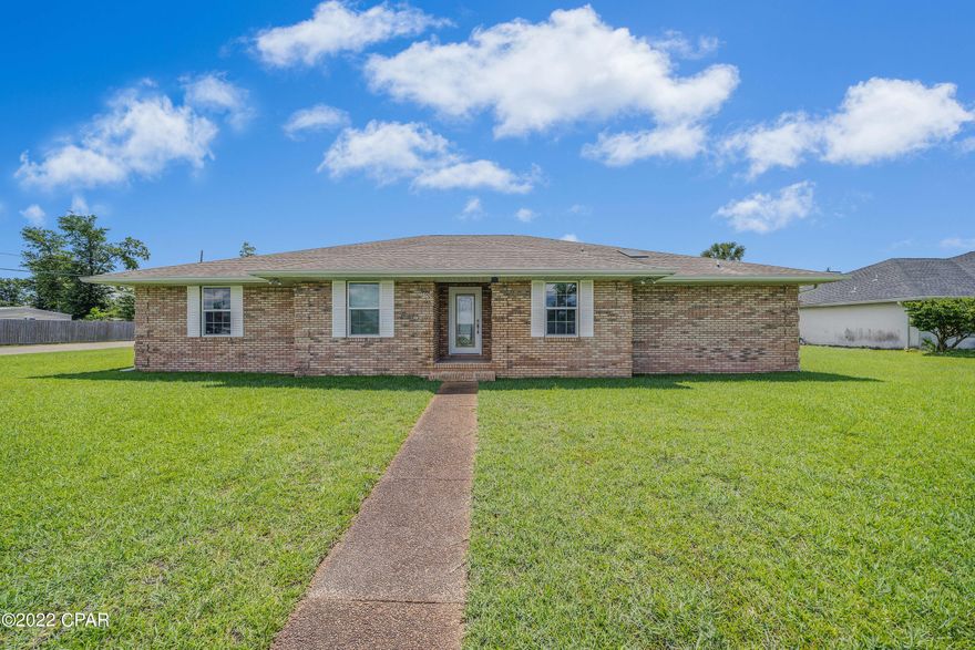 CURRENTLY UNDER CONTRACT, SELLER WILL CONSIDER BACKUP OFFERS This DREAM home is now waiting for new owners in Lynn Haven, Florida. If plenty of space is what you desire, then look no further. This stately, ALL brick Custom Home that is perfectly situated on a large, highly desired corner lot could be yours. As you arrive at this spacious property, you'll immediately take notice of the side entrance driveway, allowing the unobstructed beauty of the home to shine through and along with the charming curb appeal. This 4 bedrooms/2 bath ''split bedrooms home'' was truly made for both entertaining, plus a Bonus/Office, and with plenty of space and a wonderful backyard. You'll be able to enjoy a spacious living room with a cathedral ceiling, an amazing formal dining room, charming and well lit breakfast nook, an extraordinary master suite with a huge

walk-in closet, large master bathroom, 3 additional bedrooms, and another bathroom that has a double vanity sink. This home has many extremely desired features from immaculate new doors, energy efficient double pane windows, to a chef's kitchen which includes a SubZero Refrigerator, luxurious wood framed Asko Dishwasher with stainless steel tub, Frigidaire Induction range with "Air Fry" oven, and an over the range convection microwave hood to name a few.

Enjoying the cozy and inviting Gas Fireplace on those cool Florida evenings, along with a soothing hot tub on a screened-in porch could be a special touch to end your day.

This home is also beautifully landscaped and has a Deepwater well for irrigation, underground drainage, gutters, water softener for the whole house, private wooded fencing encompassing the property, a storage shed with two covered concrete carport spaces, and so much more.

This custom home is immaculate, well cared for, and awaiting new owners to create new, lasting memories.