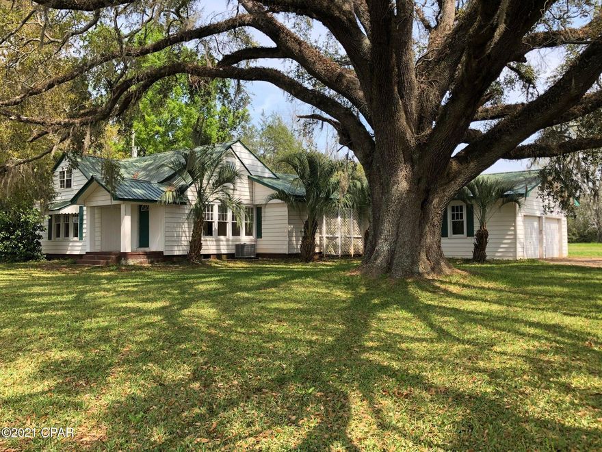 RECENTLY UPDATED WITH NEW PRICE. (see attached appraisal))  Big Country Home sitting among Huge Granddaddy Oaks. Home boast 5 bedrooms 3 baths , includes a 1 bedroom apt upstairs. Sitting on .85 acre With stunning views. Family room has a fireplace. Master bath has a Jacuzzi , SS appliances , new paint, new carpet and floor covering throughout home. Close to Fl.and Al state line. Rent the apartment for income or use for family or office.  Note-there is a Mobile home on an adjoining acre that can be purchased separately.