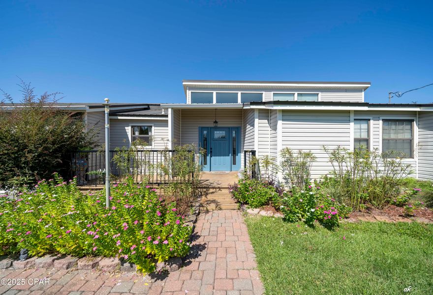 Welcome to your dream home on the outskirts of Panama City! Just 2½ miles from 23rd Street dining and shopping, this beautifully maintained 3BR/2BA, 2,322 sq ft home features a durable metal roof, solar panels, and no HOA. Inside, the sunken living room boasts soaring 23-ft vaulted ceilings, natural light, and built-in bookshelves. The remodeled kitchen offers quartz countertops, stainless appliances, induction cooktop, mobile island, and walk-in pantry. The master suite includes vaulted ceilings, dual walk-in closets, and a large bath with double sinks, walk-around shower, soaking tub, and patio access. Two additional bedrooms share a farmhouse-style bath with a clawfoot tub. Outdoor living shines with a 683 sq ft deck, 16x16 screened porch, 20x25 bar/workshop, and smokehouse. This home is move-in ready and waiting for its new owners.