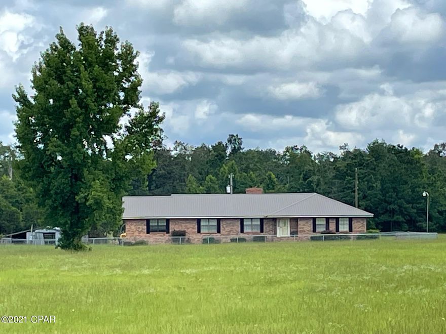 Great Country home on 5 acres. 2600 Sq ft heated and cooled, 3BR/3B, HUGE family room with Gas fireplace, large Florida room,  Huge kitchen with breakfast area, pantry and center island , formal living and dining rooms, central vacuum unit, large bedrooms, large patio all on 5 surveyed acres that is basically all in pasture so bring your horses. There is a good metal barn for equipment and storage. The home has chain link fencing around it to keep livestock out and pets in! This home has a hot tub installed in one side of the garage but can be removed if preferred. The home is all brick and vinyl for low maintenance. A brand new well just got installed. There also is a transferable Terminex Termite Bond. Great home for family or ent