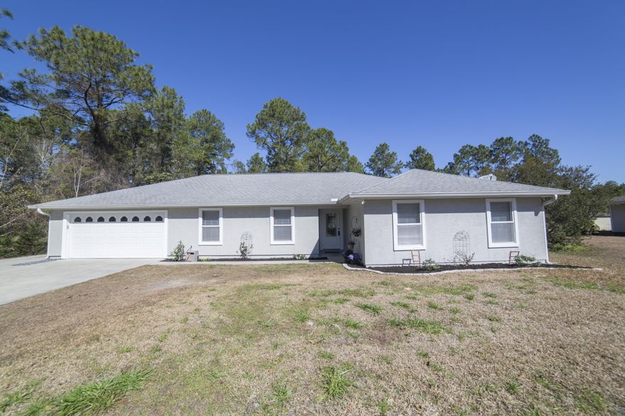 This 4/3 home is freshly painted (inside and out) with 2 master suites, open floorplan, tiled floors (except bedrooms), sound proof walls, and nature behind you as well as a beautiful pond (with fish)! The kitchen has custom cabinets, stainless Kenmore appliances, breakfast bar, tiled backsplash, and pantry. The living room has vaulted ceilings and a wood burning fireplace. The main master bedroom is HUGE with a walk-in closet with en suite bathroom and double vanity. The 2nd master has a full bath as well and another large walk in closet. New A/C in June 2013. The back yard has a 12x12 detached yard building and above ground pool (new liner is on order) with deck. On almost a half acre with 2 covered sitting areas in the back, ample parking, with an extra pad for a boat/RV