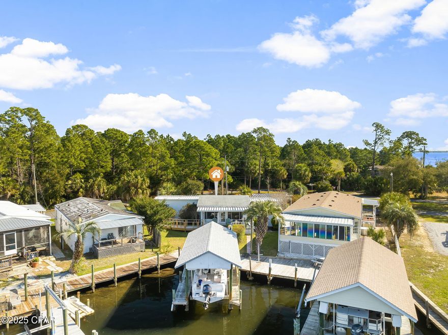 Welcome to your waterfront dream home with that million-dollar view that you've been looking for! Located on the east end of PCB, set back in a quiet serene setting! This beauty offers the dream of waterfront ownership with a 7,000 lb. boat lift and boat house and your own dock. This 2-bedroom, 1.5 bath home will come fully furnished and ready for you. This waterfront location is just minutes to the Pass and the Gulf!  With NO HOA fees, a full-service Marina just around the corner. covered parking and much more. Don't wait this one will go quickly! Call today to schedule your private showing.