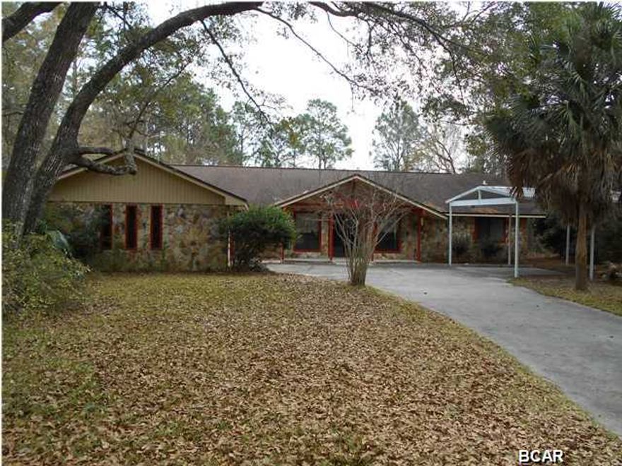 If you like large rooms, and need lots of storage, you have to see this home. With a little updating, this home will be perfect for an active family. Sitting on two lots that are just over one acre of land, there is even a 12x27 out building for all your projects. Inside, you will find a dining area, and a formal dining room that adjoins a cozy den. The large living room has a fireplace and a wet bar, and plenty of shelving. The kitchen has lots of solid wood cabinets, a small island, and comes with all newer appliances. All of the bedrooms have real bamboo flooring, and are very nice size. Both baths have double vanities. The Florida room is an incredible 20x35 and is accessible from the living room, dining area, and master bedroom. Both the front and back yard have lots of