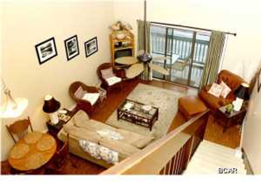 This 2-story condo with breath-taking and unobstructed views of the gulf is completely remodeled and fully furnished. There is also a community pool and BBQ Pit area. It's a 2BR/2BA unit at the West End of the beach located right next to the Carousel Supermarket making grocery shopping a breeze. This home also has wide open gulf views! **The beach in front of this unit is protected and can never be built on!** Home features two story living area with soaring high ceilings, plus each bedroom has its own bathroom! The home has one bedroom downstairs, and the other is a loft styled bedroom upstairs, making it feel nice and roomy! Home also features all new appliances including washer/dryer installed in 2009 that have barely been used, as well as new AC. This unit is VERY clean and well